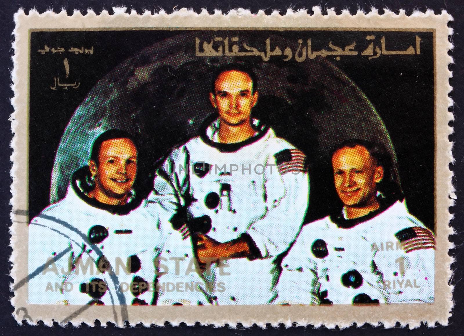 AJMAN - CIRCA 1973: a stamp printed in the Ajman shows Crew of Apollo 11, Neil Armstrong, Buzz Aldrin and Michael Collins, Moon-landing, Apollo 11, circa 1973