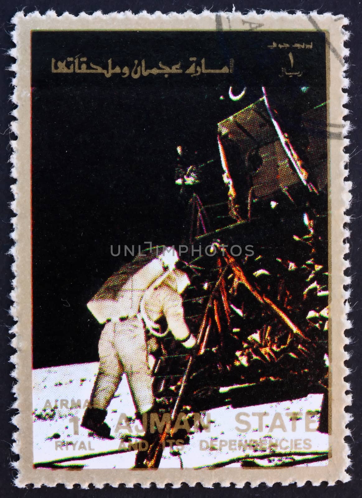 AJMAN - CIRCA 1973: a stamp printed in the Ajman shows Edwin Buzz Aldrin Stepping out of the Eagle, Moon-landing, Apollo 11, circa 1973