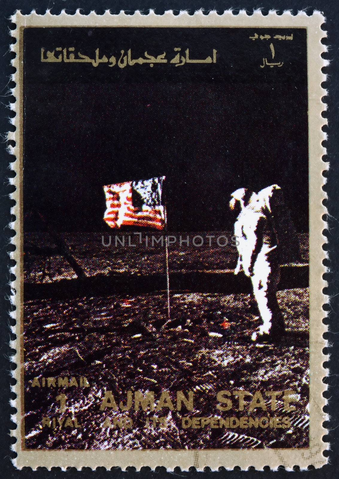 AJMAN - CIRCA 1973: a stamp printed in the Ajman shows Edwin Buzz Aldrin Salutes U.S. Flag on the Lunar Surface, Moon-landing, Apollo 11, circa 1973