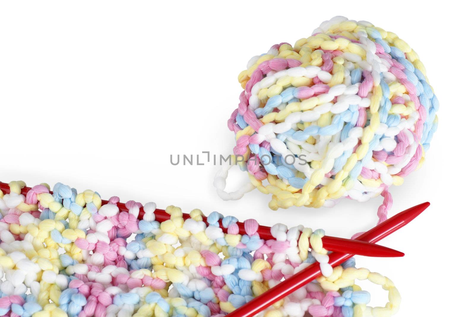 Beautiful baby or arts and crafts knitting background with red needles, pastel or baby colors wool or yarn.