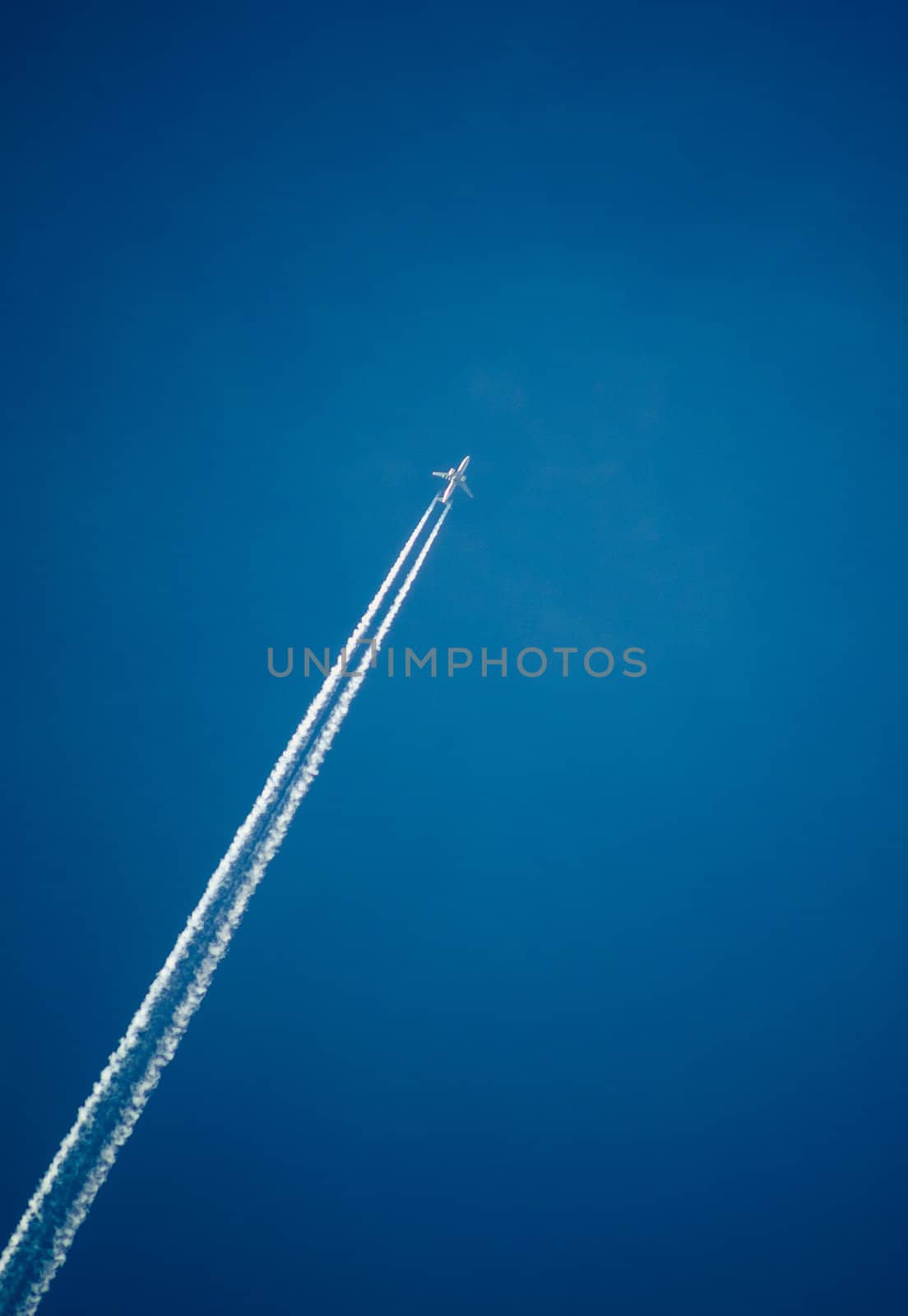 Contrail in the dark blue sky, a beautiful show