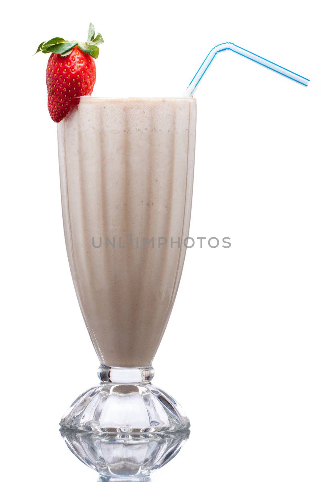 A delicious cold fruit smoothie or milk shake decorated with strawberry. Isolated on white.
