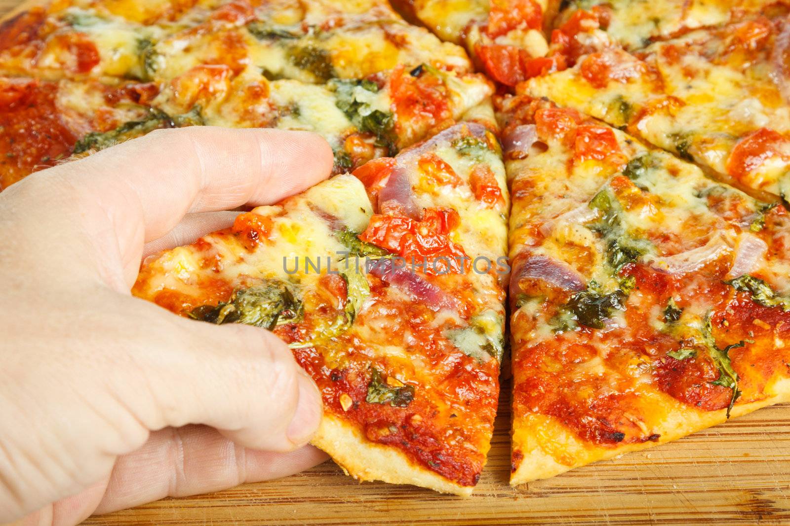Hand grabbing slize of pizza by Jaykayl