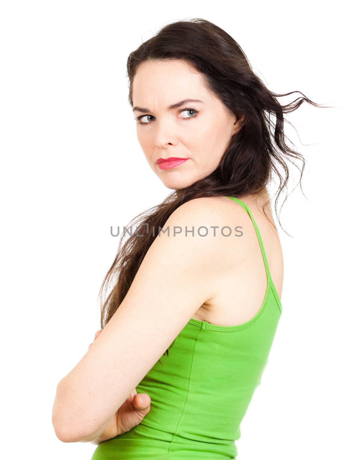 Close-up of a  jealous unhappy beautiful young woman looking over her shoulder at someone. Isolated over white
