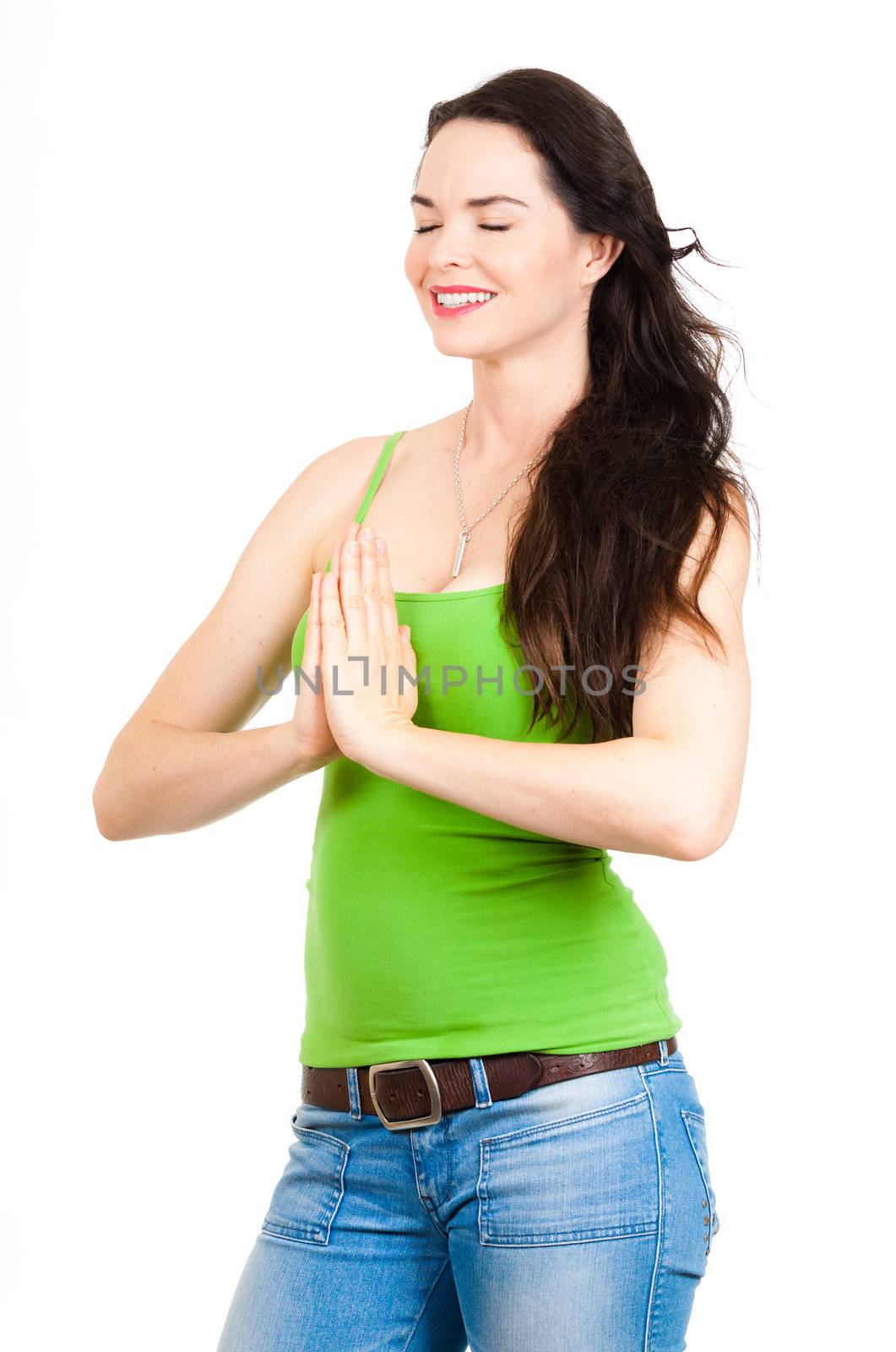 Pretty young woman relaxing with hands together in a yoga pose. Isolated on white.