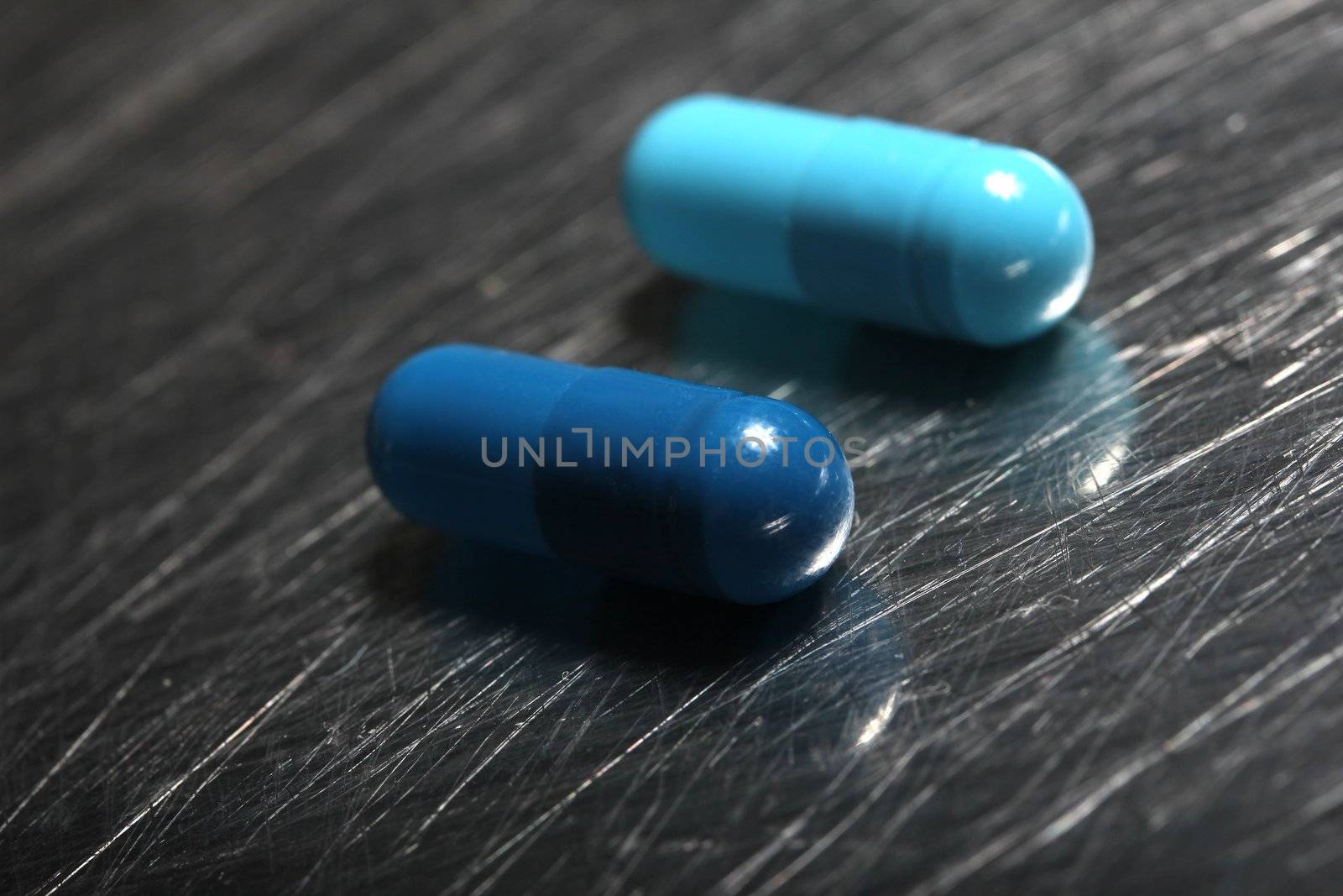 colored medicinical capsules on a steel plate