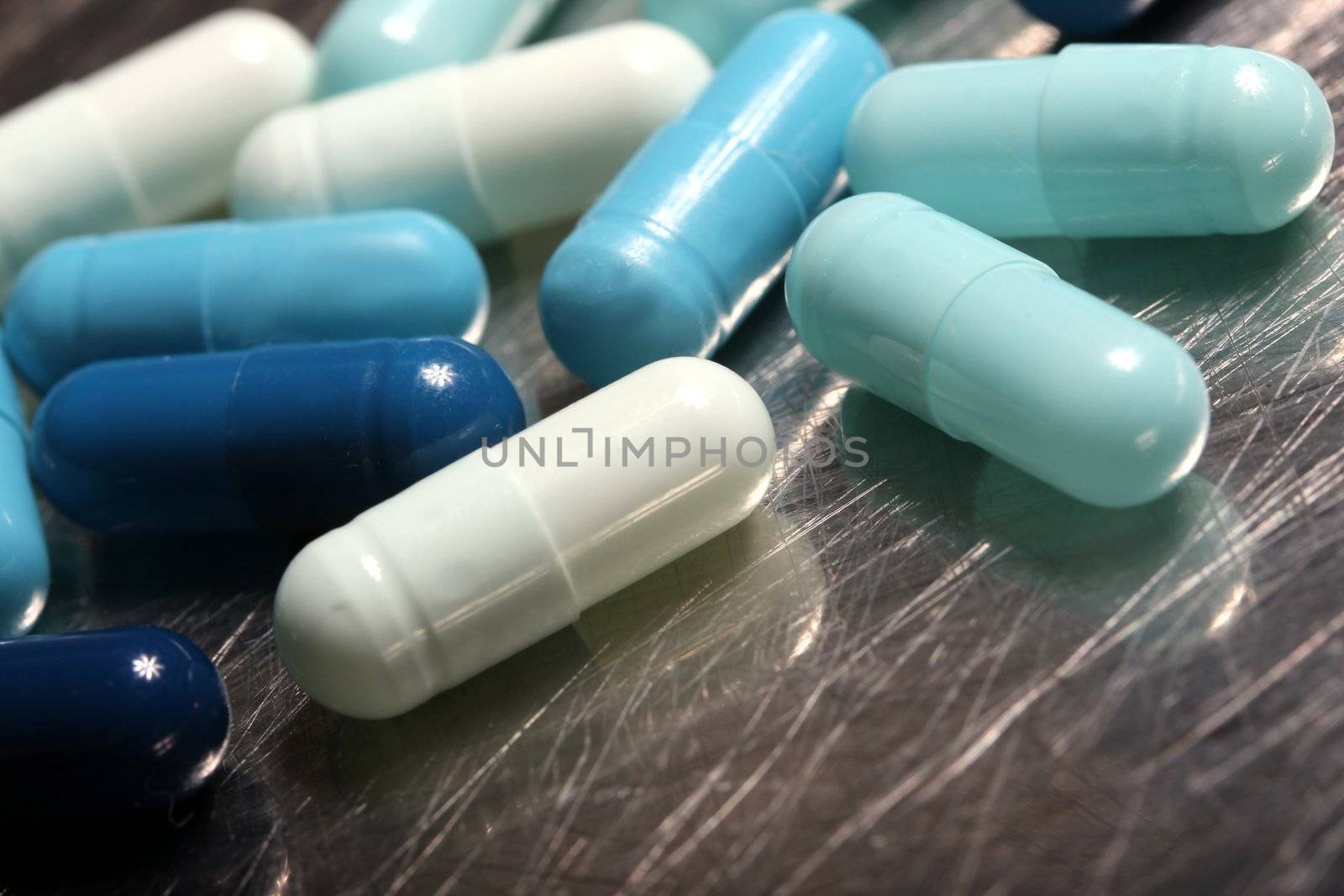 colored medicinical capsules on a steel plate