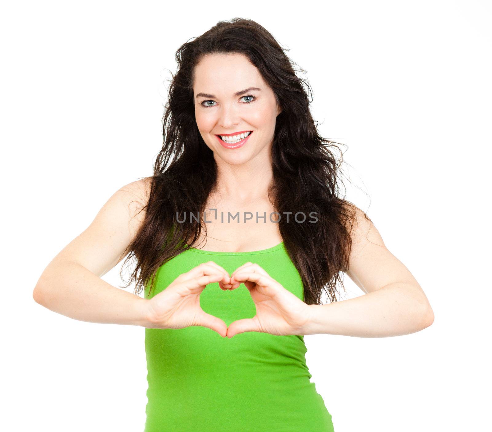 Beautiful smiling young woman symboling a love heart with hands. Isolated over white.