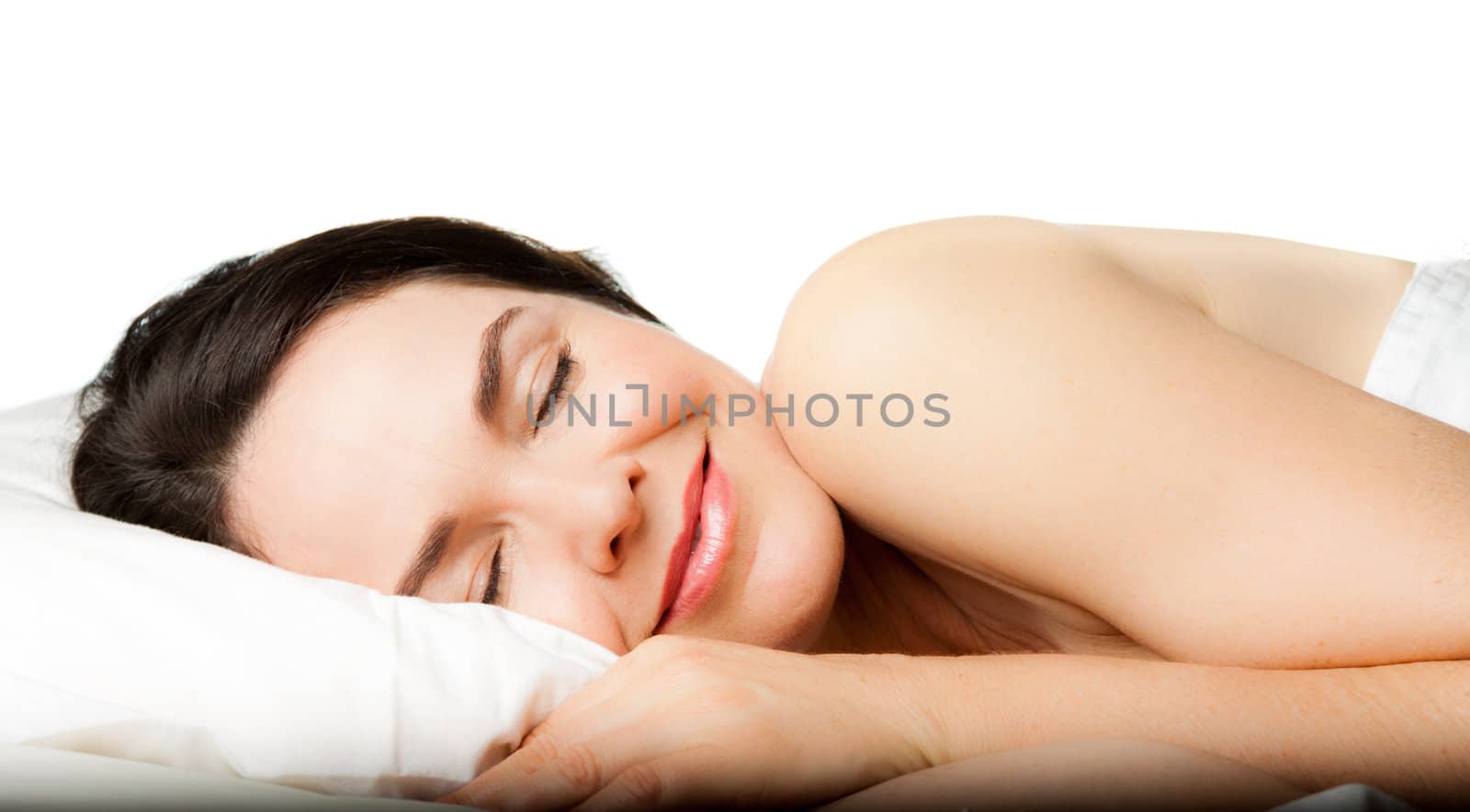 A beautiful young woman sleeping peacefully. Isolated over white.