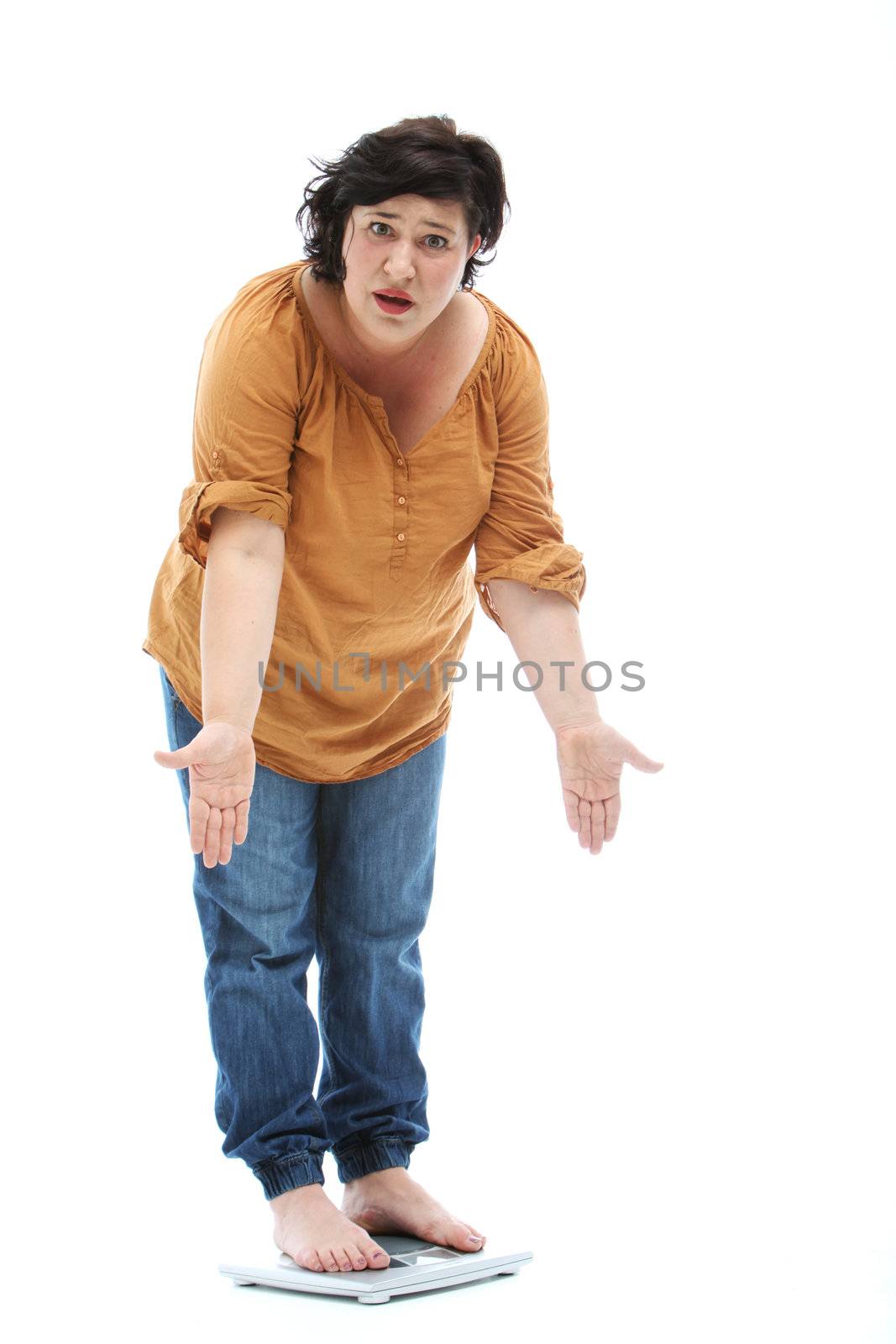 Women with weight problems is on a scale - cutout on white