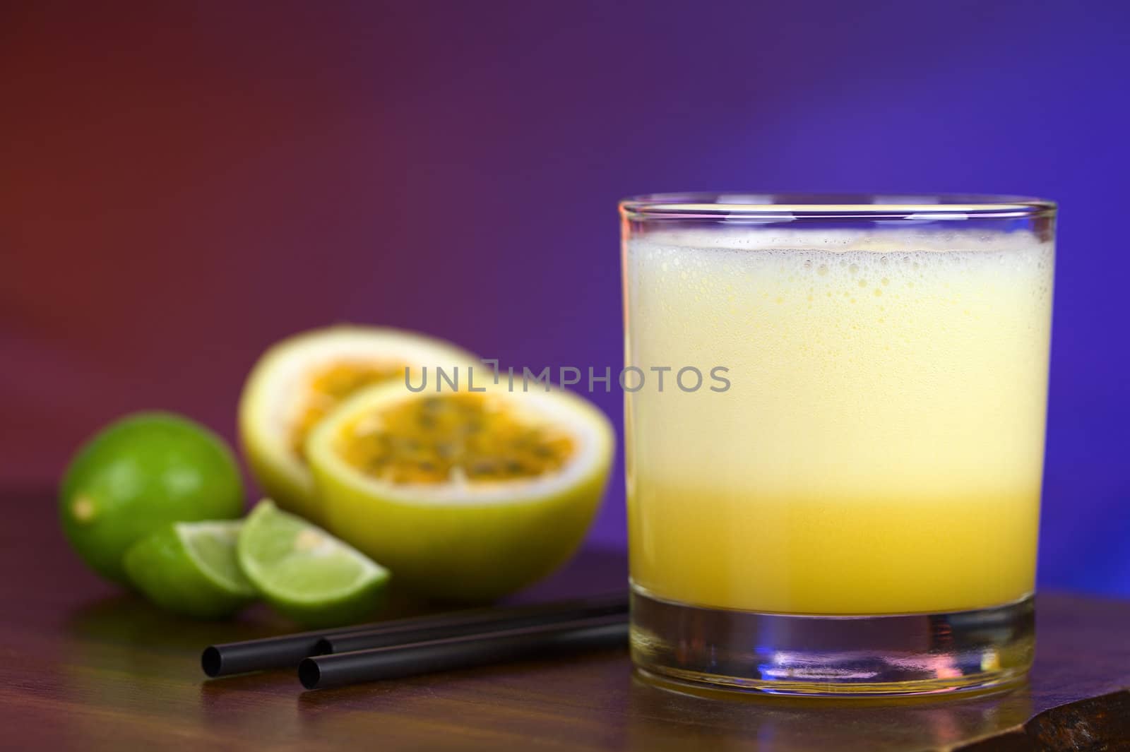 Maracuya Sour, a popular Peruvian cocktail made of maracuya and lime juice, pisco, syrup and egg white (Selective Focus, Focus on the front of the glass)