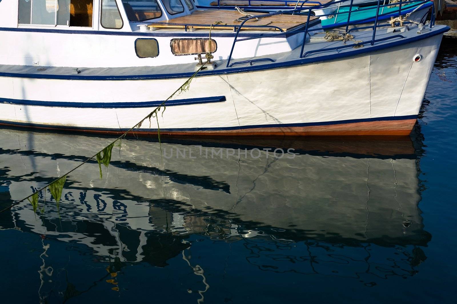 An image of reflection in the water part of ships