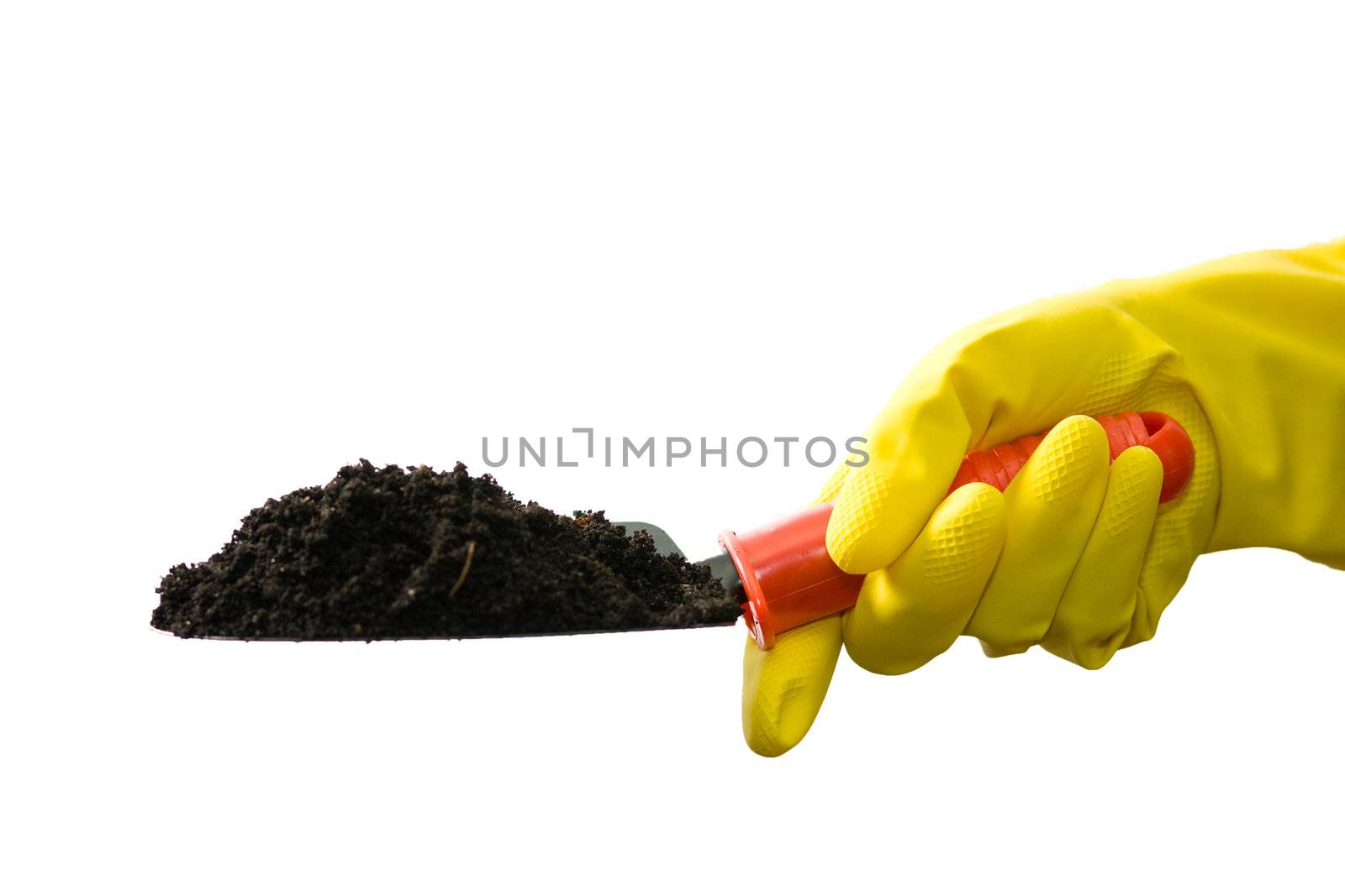 Stock photo: an image of a hand in yellow glove with garden shovel