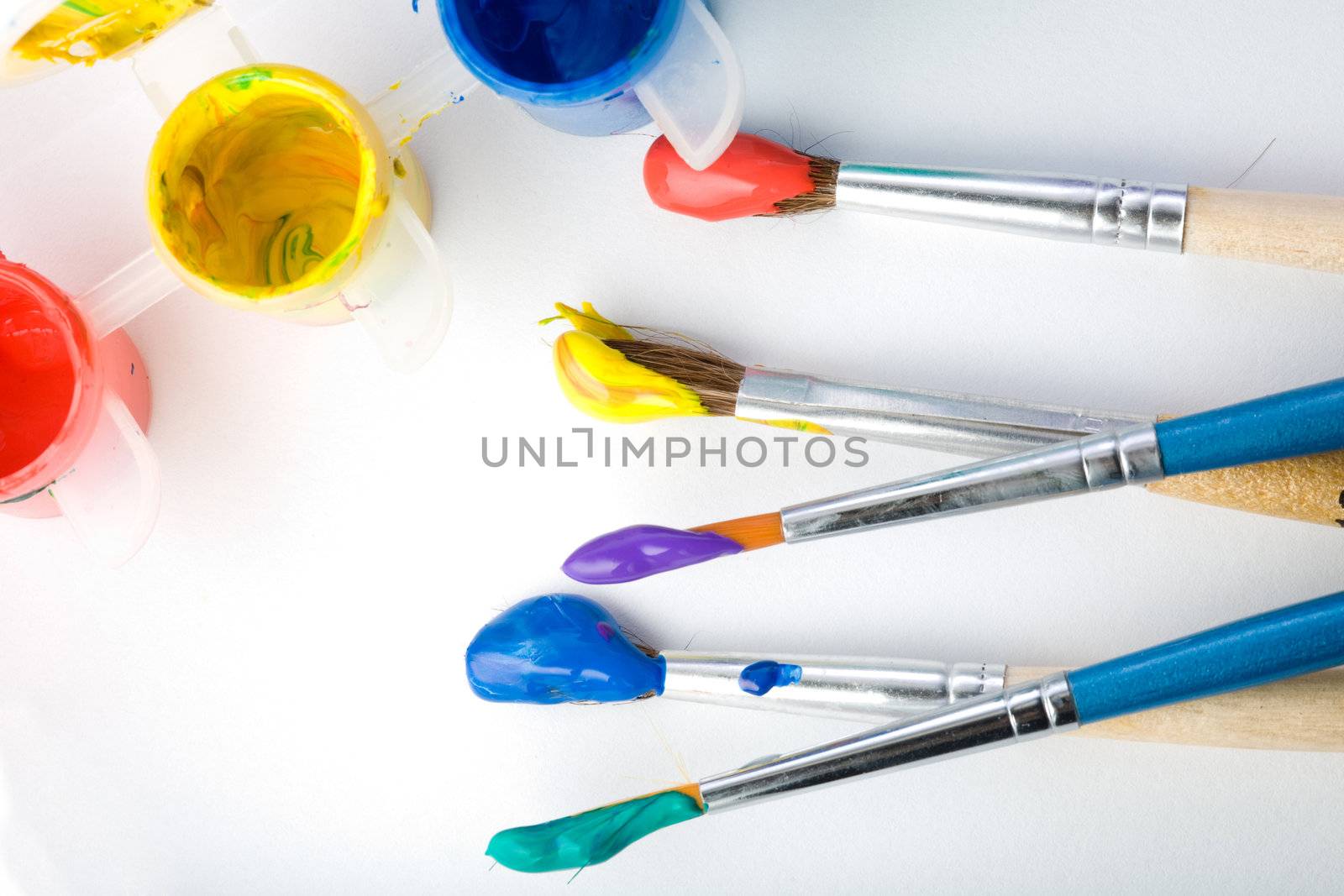 Stock photo: an image of five paintbrushes and three paints