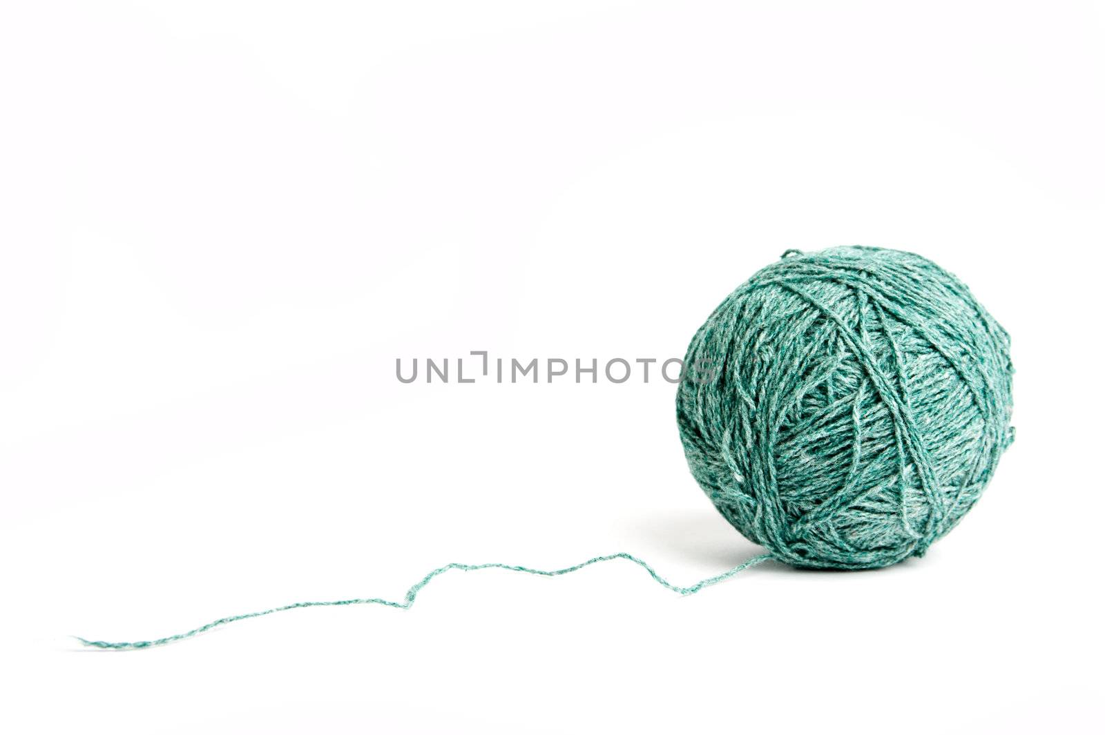 An image of a ball of green yarn on white background