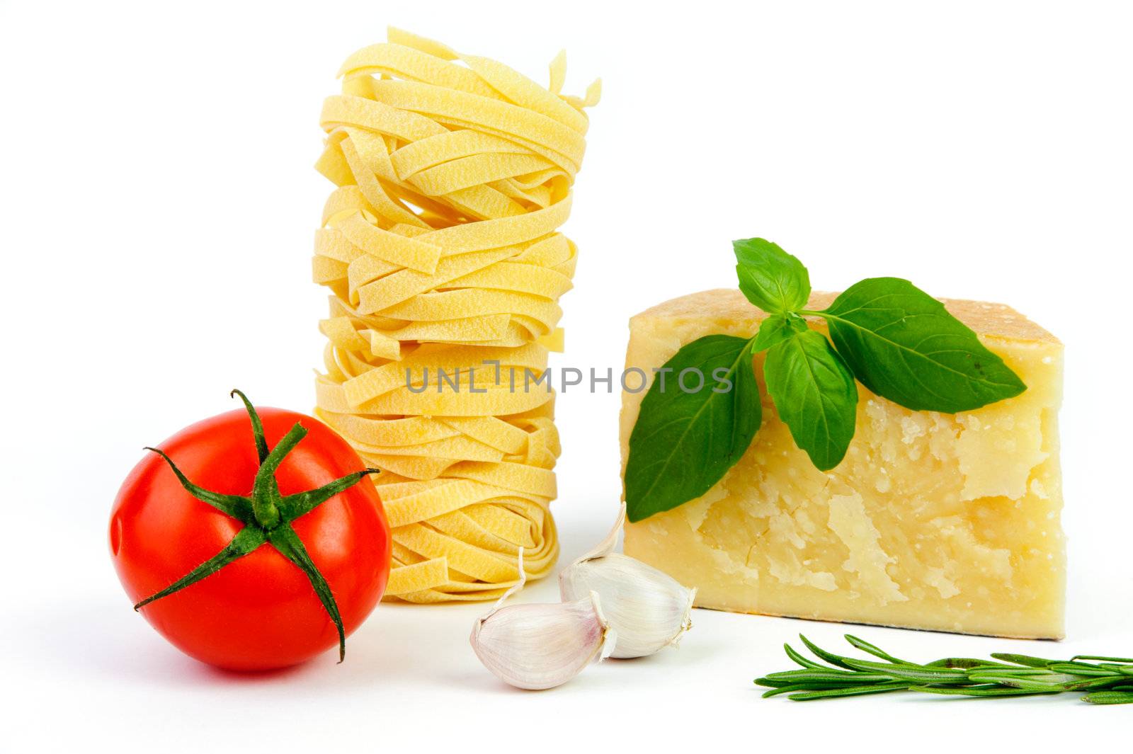An image of cheese, tomato, pasta, garlic and basil