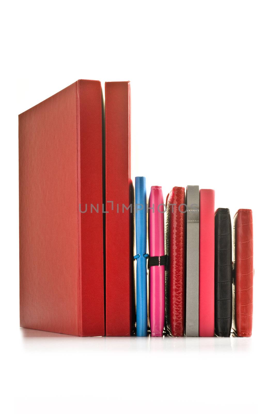 Close up of stacked up books on a white background with space for text