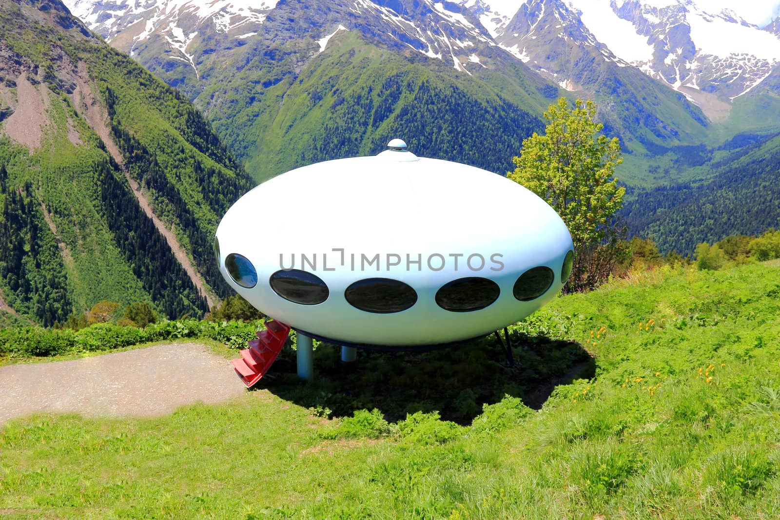 Image of landscape with Caucasus mountains and UFO