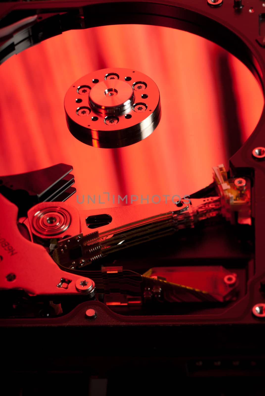 Reflective hard disk platter closeup with red light