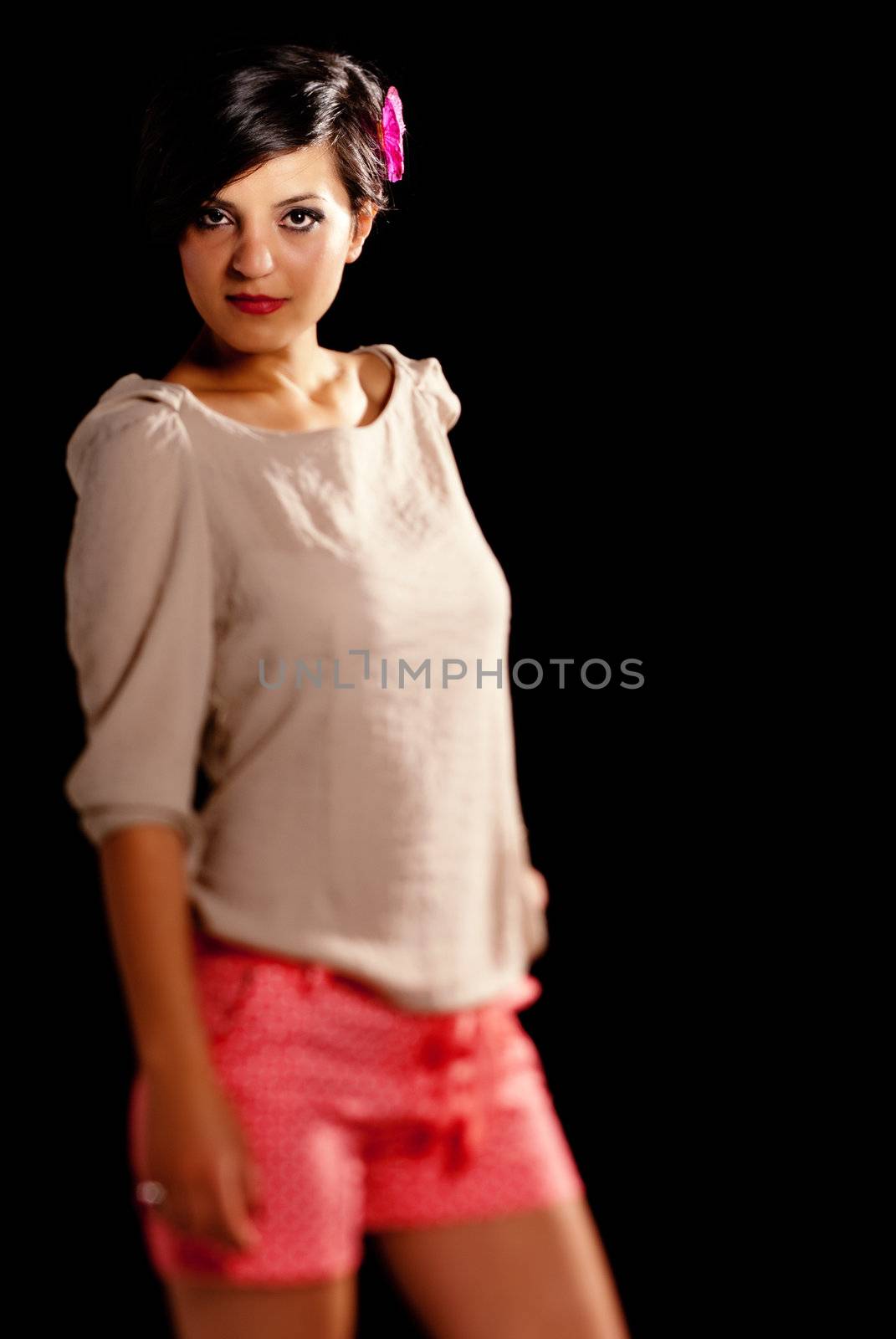 Tilt and shift play with a young girl in black studio isolated