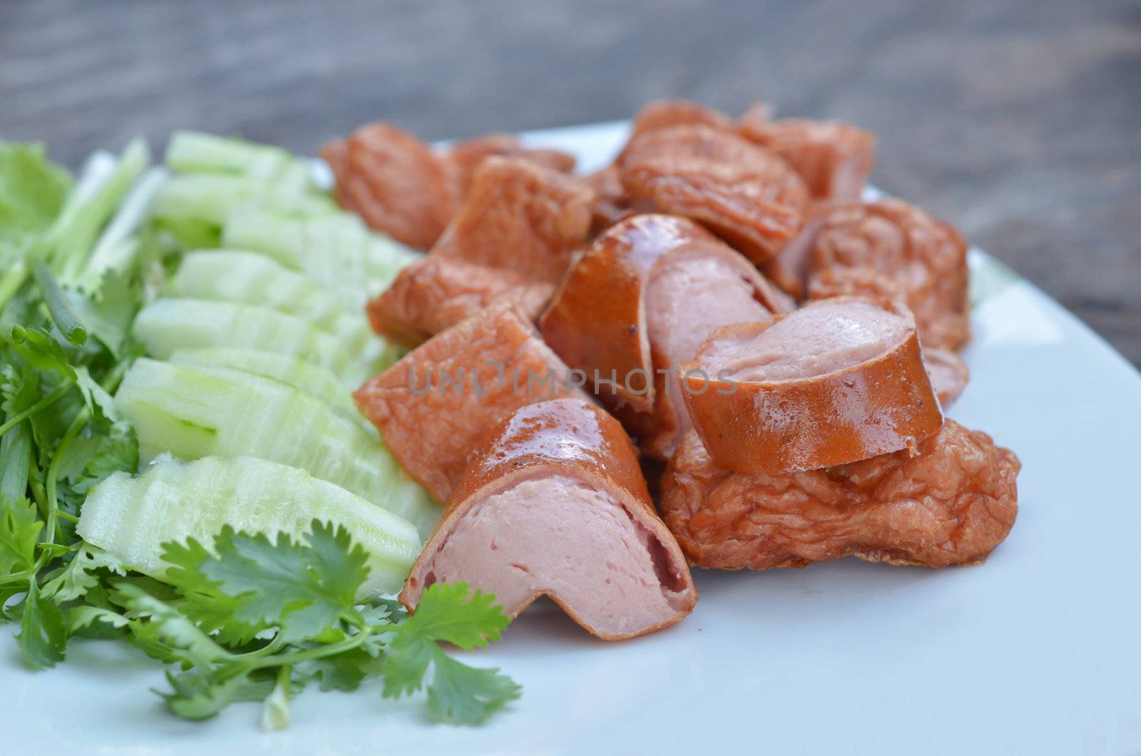  fresh vegetable and fried sausage  on white plate