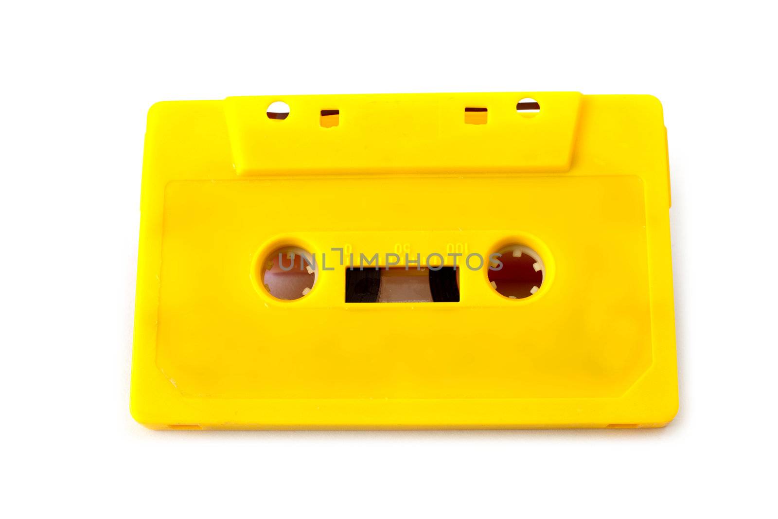 Yellow audio cassette on white background 
