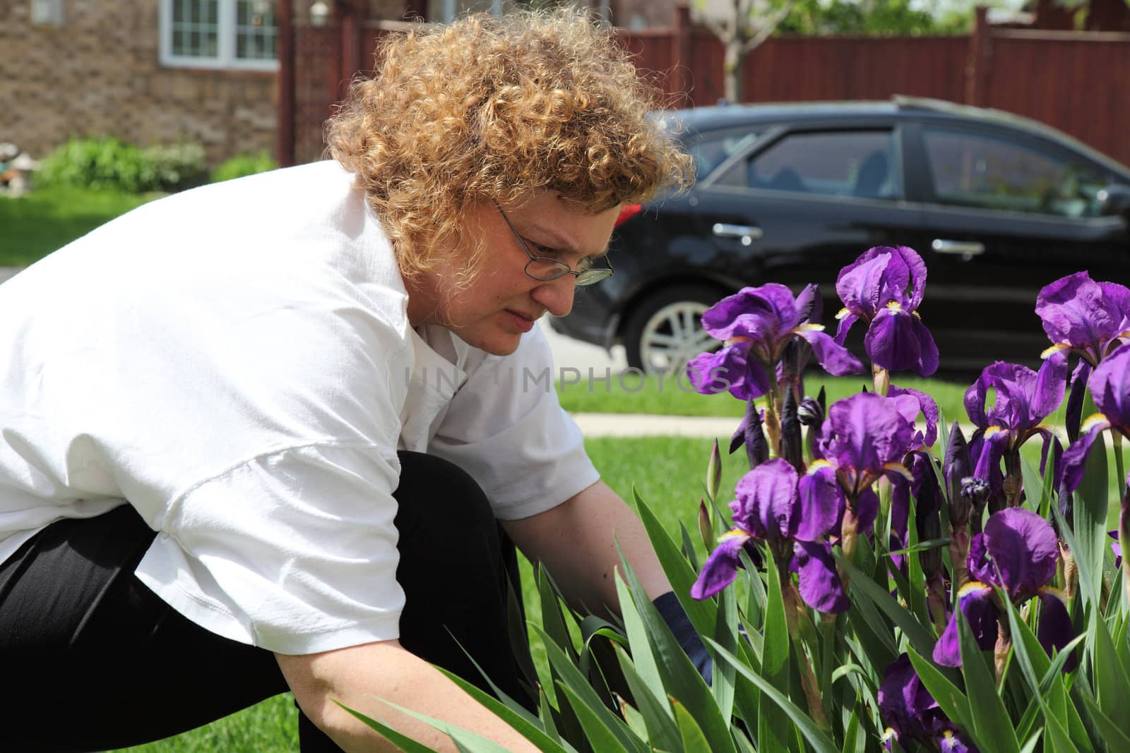 mature woman outside doing gardening 