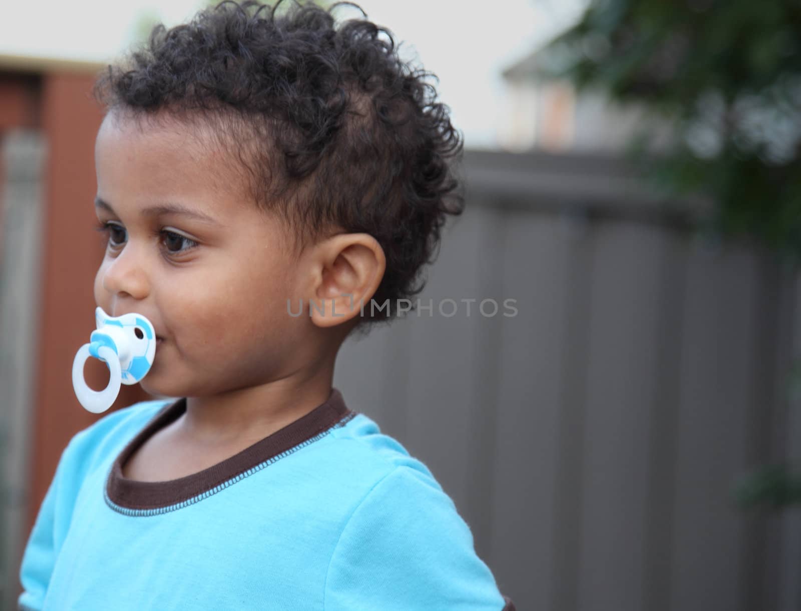 young  multiracial boy with a pacifier