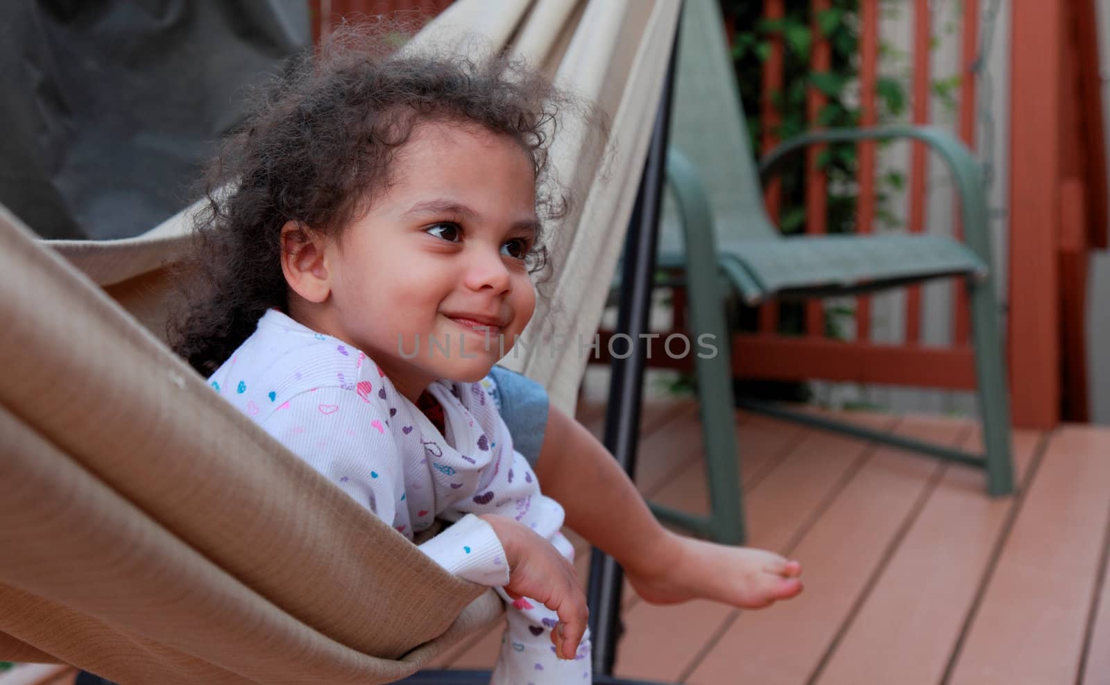 happy little girl in hammock by njene