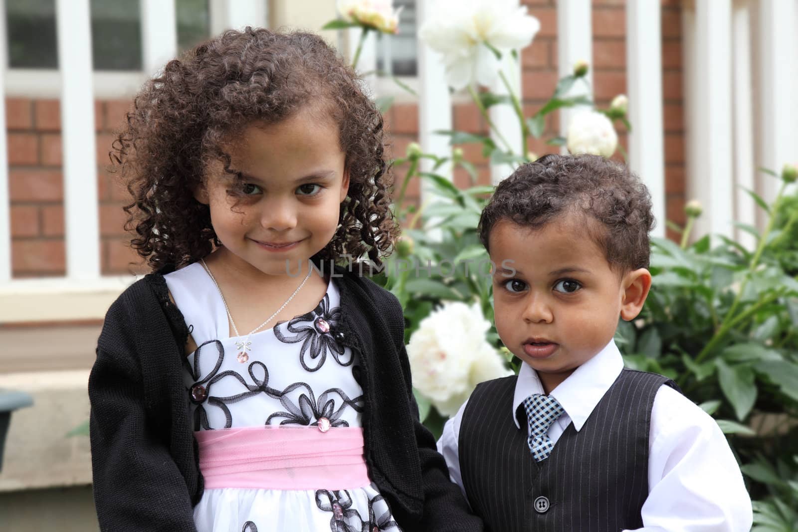 young  multiracial boy and girl portrait by njene