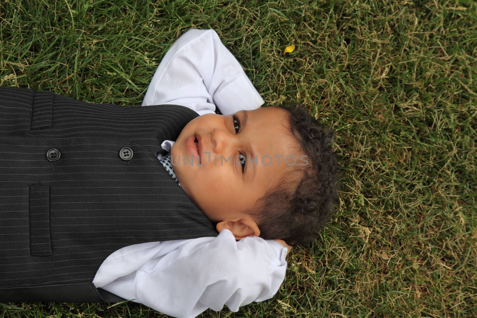 young boy lying and relaxing on the grass peaceful