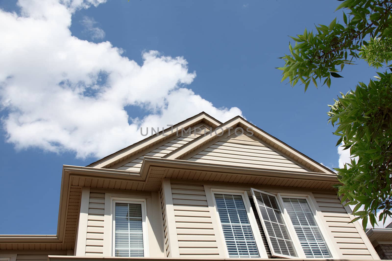 house roof peak against blue sky