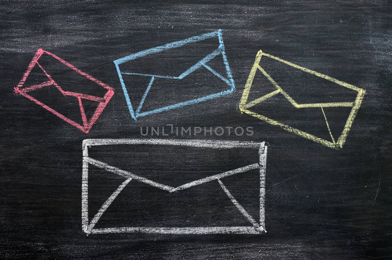 Chalk drawing of email symbols on a blackboard 