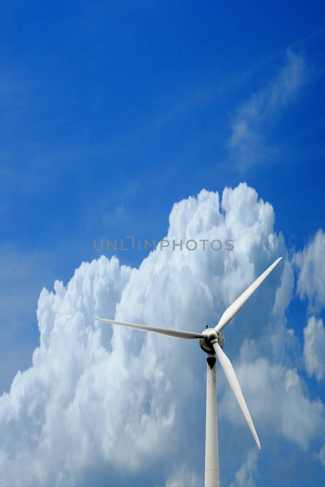 windmill generator against blue sky by njene