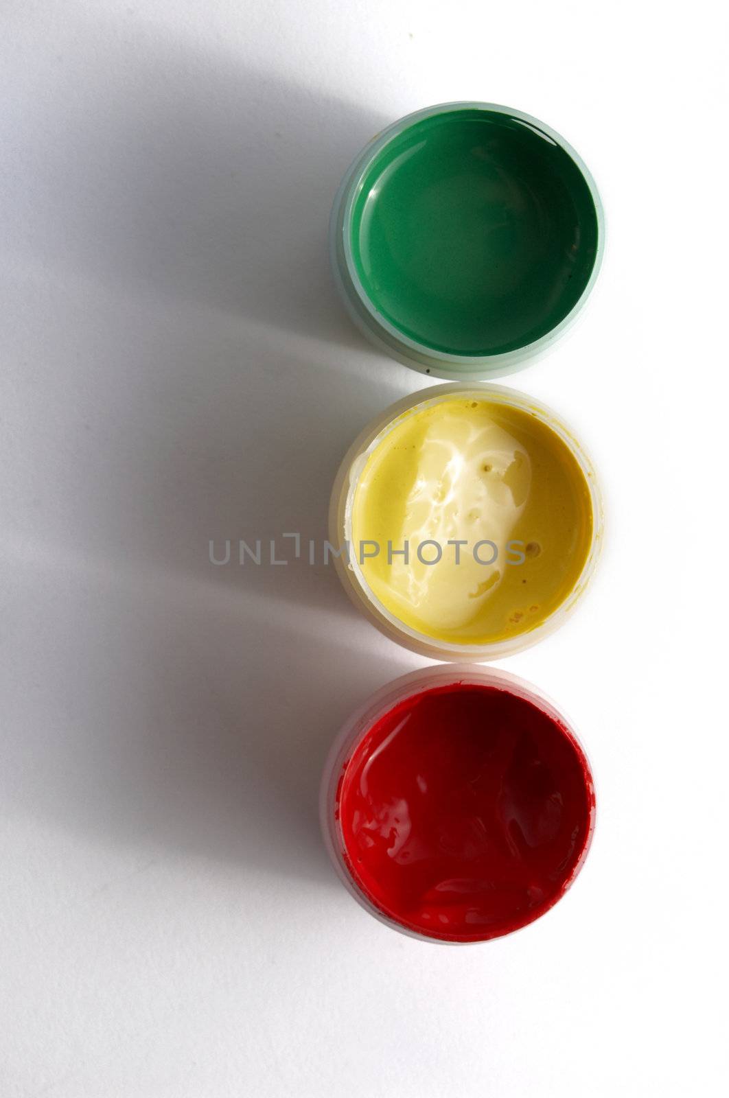 Three pots with paints of different colours