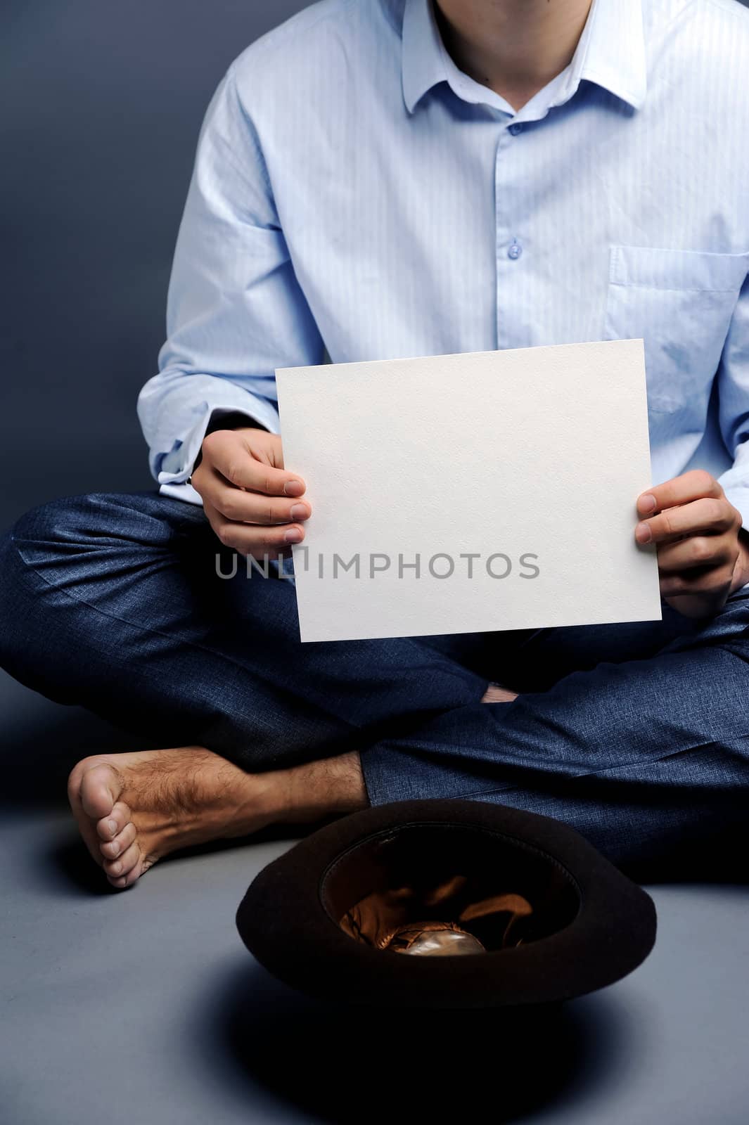 An image of a beggar with a hat and a blank sheet of paper