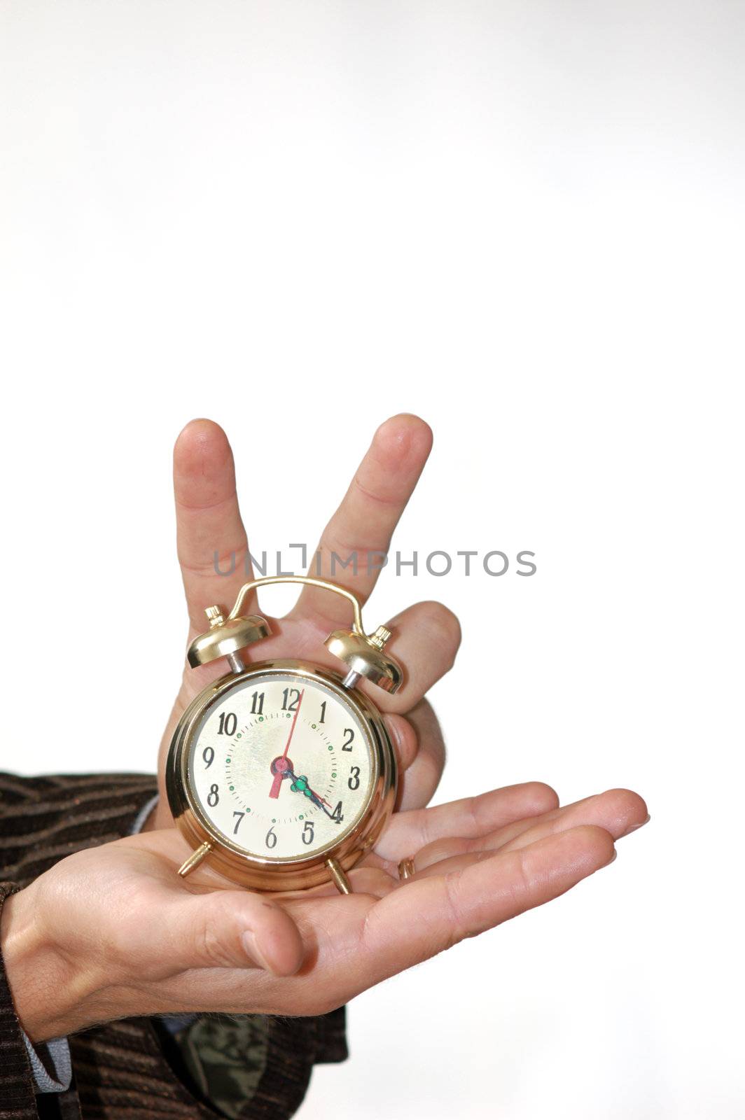 A man keeping an alarm clock in his palm