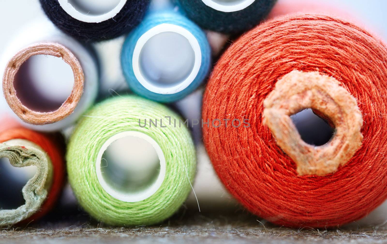 Front view on sewing spools. Macro colorful photo