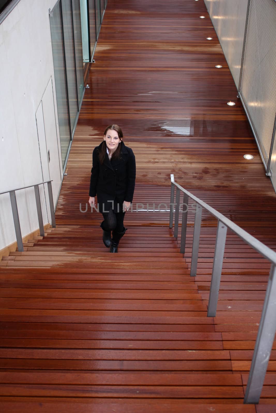 Young Attractive Brunette Woman With Black Clothing Walking Up Stairs
