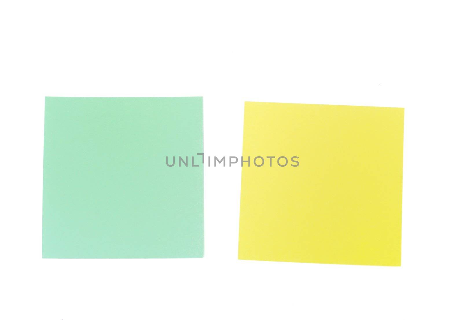 An image of yellow and green sticky notes on white