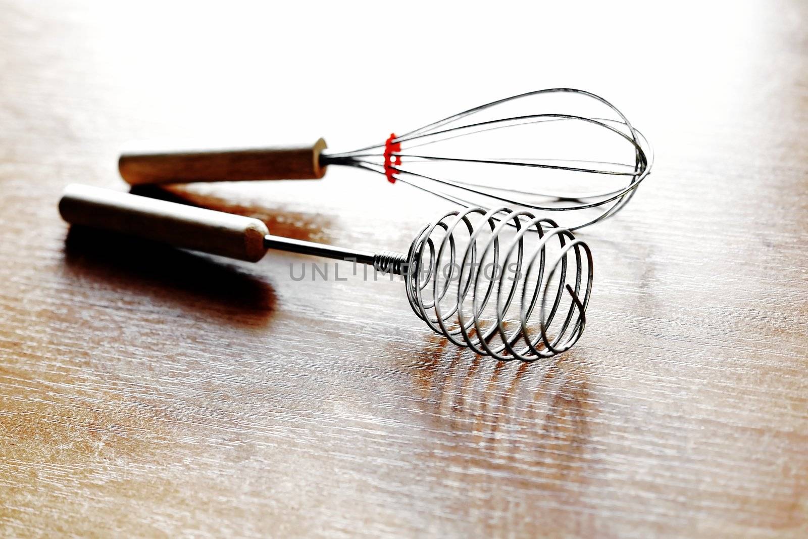 An image of two whisks on the kitchen table