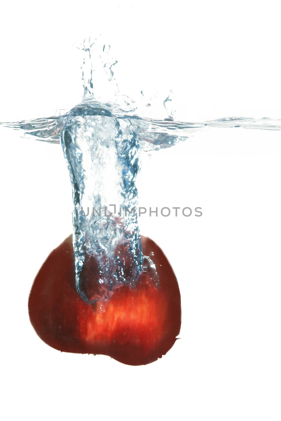 An image of red apple in water