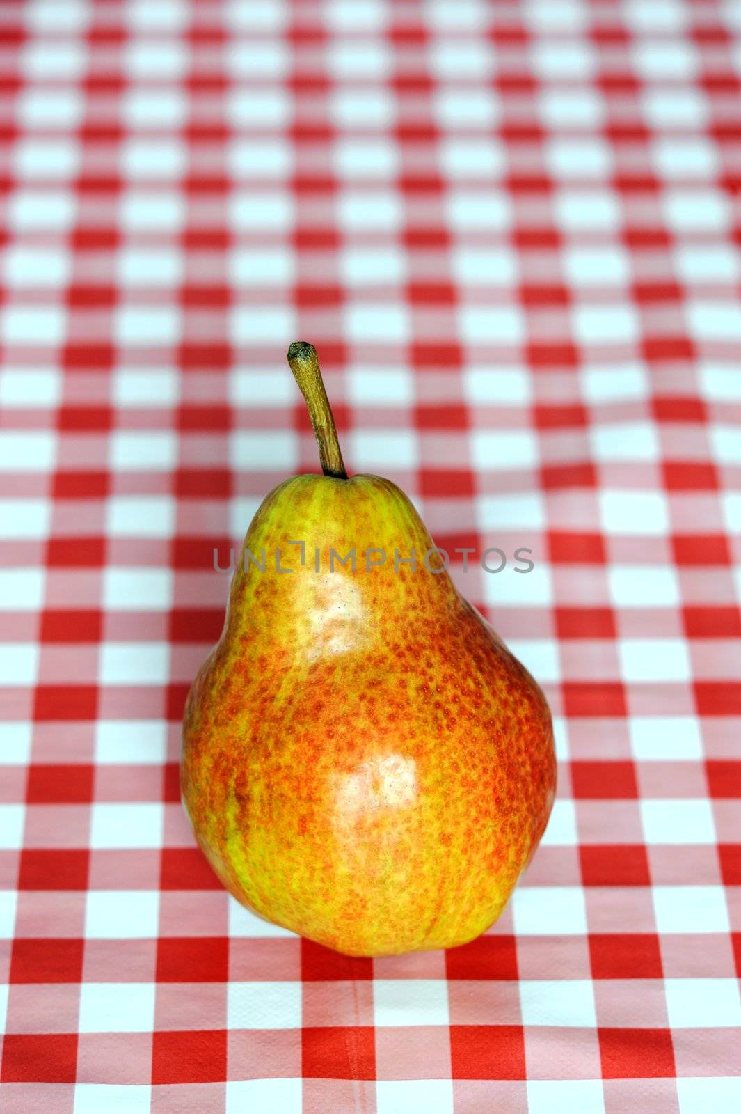 An image of a ripe pear on the table