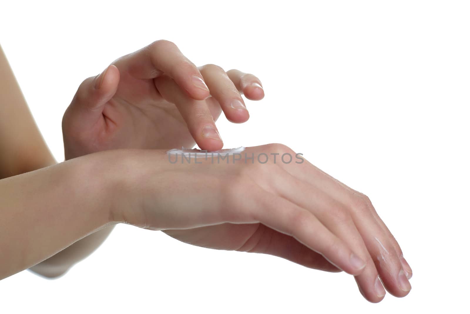 An image of woman's hand putting cream onto another hand