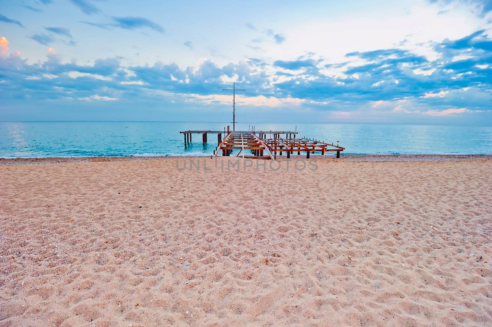 Sandy beach with a pier by kosmsos111