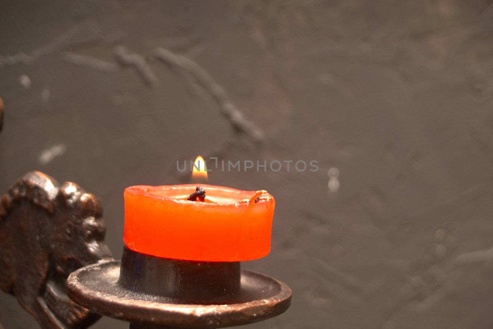 An image of a candle on a candlestick
