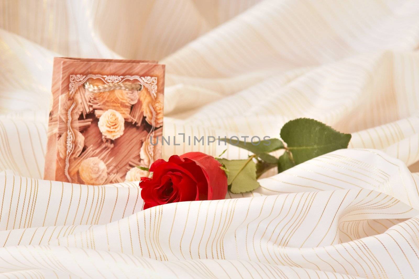 An image of red rose and box