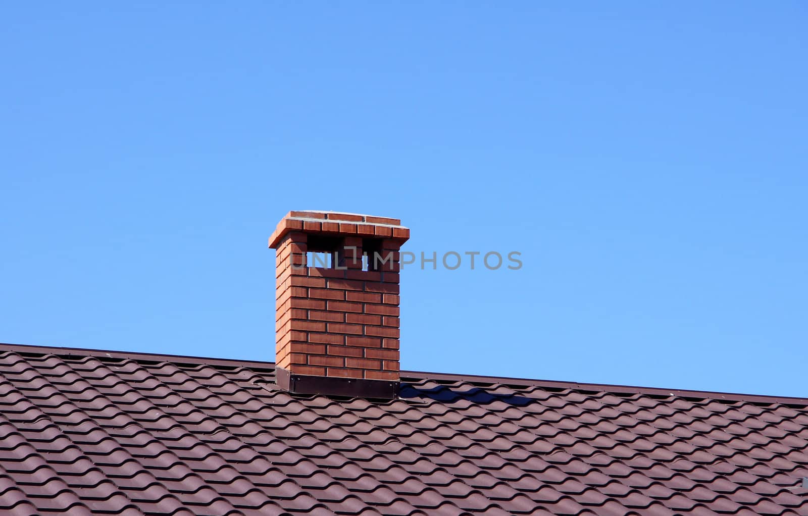 The roof and chimney with blue sky