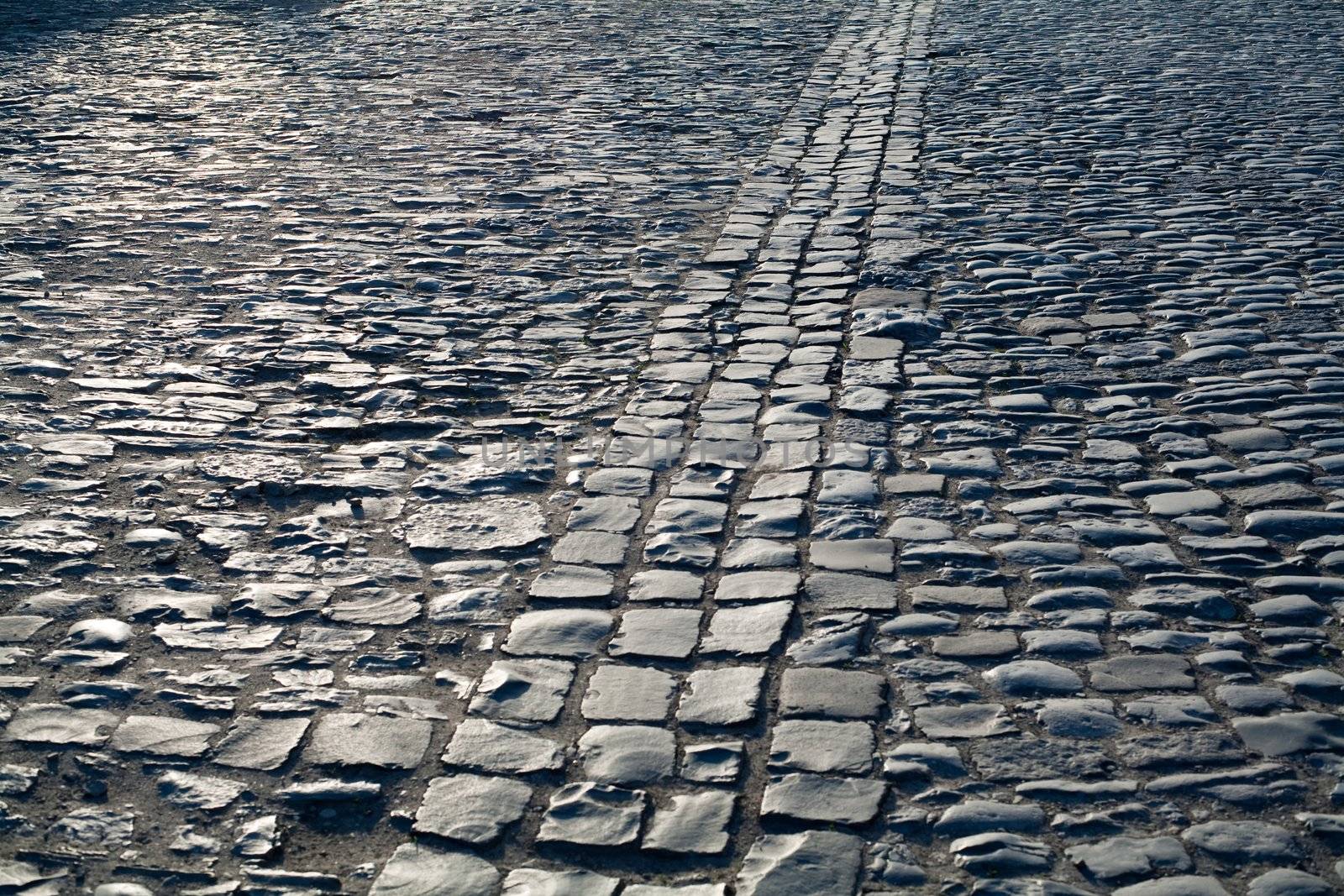 An image of an old road of grey stones