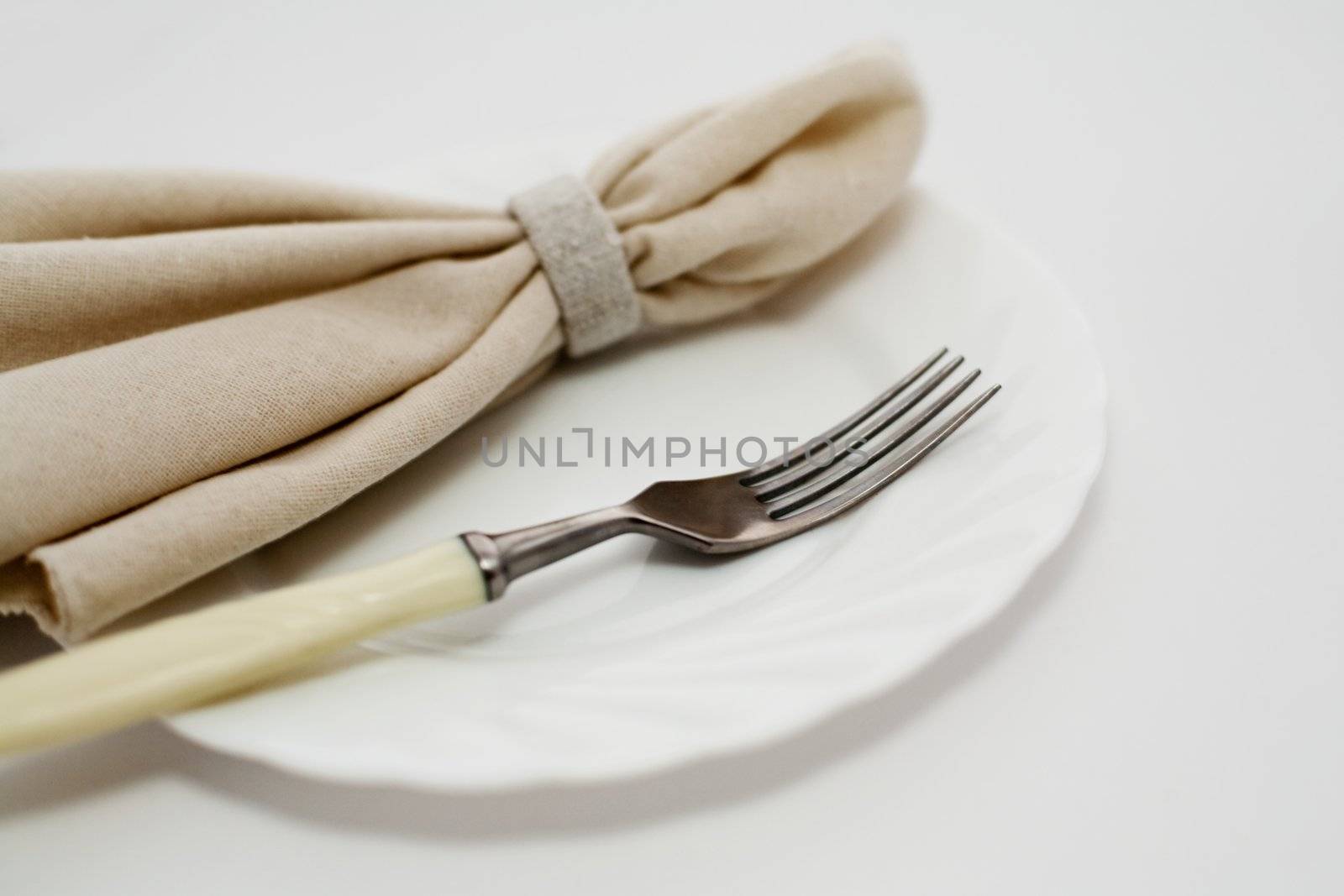 An image of fork and napkin on plate